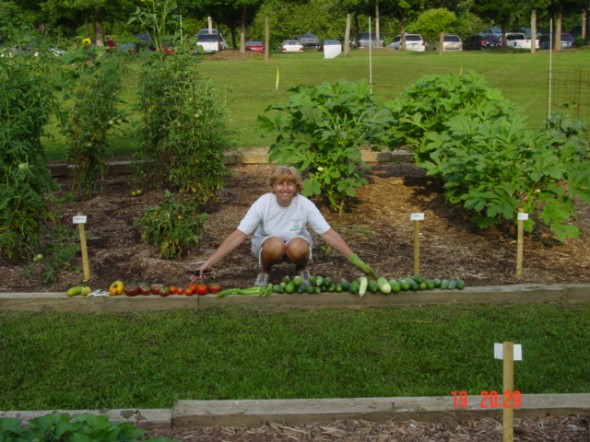 McDaniel Farm Park Workday 7-20-11 Alice showing off part of the harvest